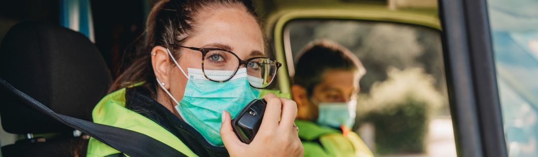 Female paramedic answering a call in an ambulance